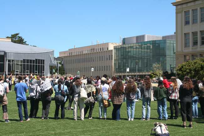 students forming a ring around the tents