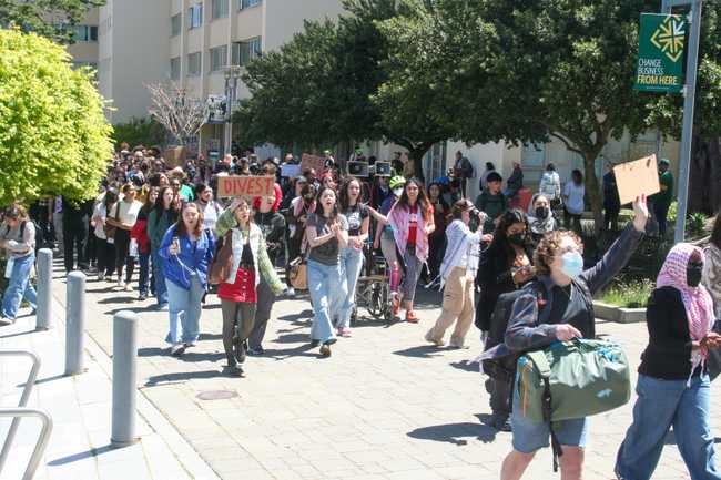 students marching to the lawn. the front of the crowd