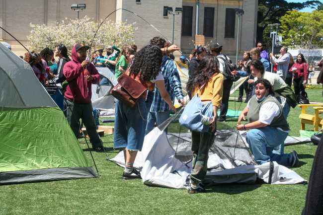 students assembling tents
